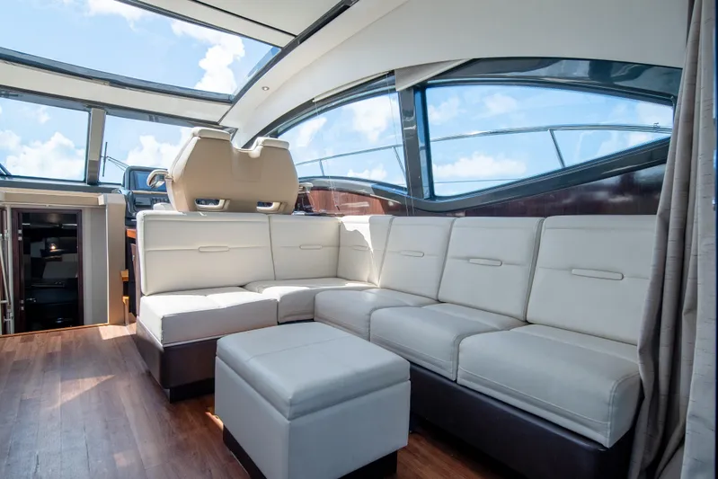  Yacht Photos Pics Luxurious interior of 2016 Sea Ray 400 Sundancer yacht with plush seating and panoramic windows.