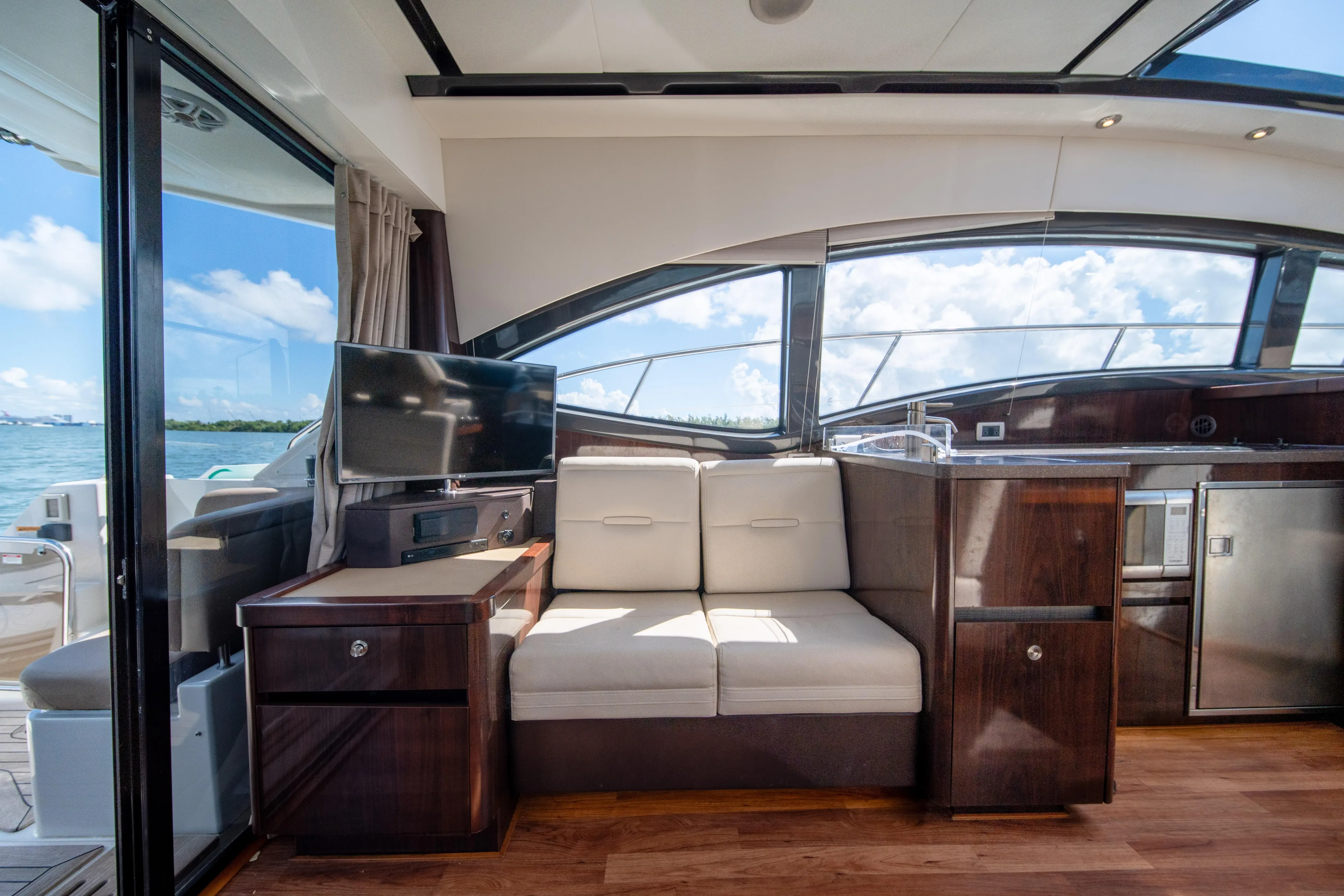  Yacht Photos Pics Luxurious interior of 2016 Sea Ray 400 Sundancer yacht with modern furnishings and scenic view.