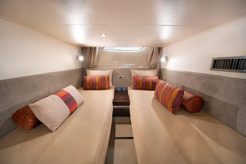  Yacht Photos Pics Luxurious cabin interior of 2016 Sea Ray 400 Sundancer yacht with twin beds and colorful pillows.