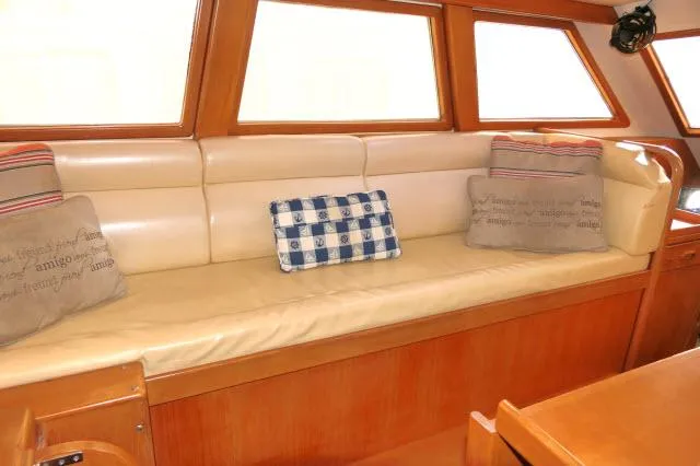 Peregrine Yacht Photos Pics Luxurious interior of 2002 Tayana 460 Vancouver Pilothouse with comfortable seating and decorative pillows.