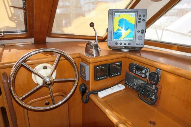 Peregrine Yacht Photos Pics Pilothouse of 2002 Tayana 460 Vancouver with navigation equipment and wooden steering wheel.
