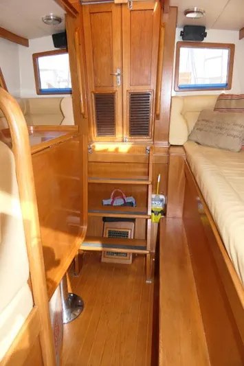 Peregrine Yacht Photos Pics Interior of 2002 Tayana 460 Vancouver Pilothouse with wooden furnishings and cozy seating.