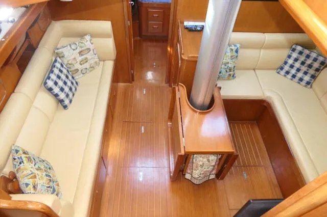 Peregrine Yacht Photos Pics Interior of 2002 Tayana 460 Vancouver Pilothouse with cozy seating and wooden flooring.