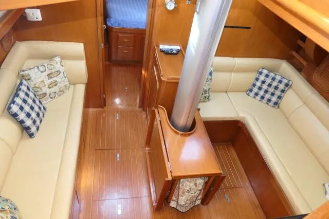 Peregrine Yacht Photos Pics Interior of 2002 Tayana 460 Vancouver Pilothouse with cozy seating and wooden finishes.
