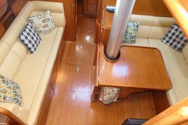 Peregrine Yacht Photos Pics Interior of 2002 Tayana 460 Vancouver Pilothouse with wooden flooring and cushioned seating.