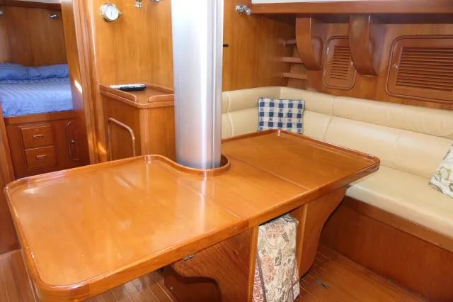 Peregrine Yacht Photos Pics Luxurious wooden interior of 2002 Tayana 460 Vancouver Pilothouse yacht with dining area.