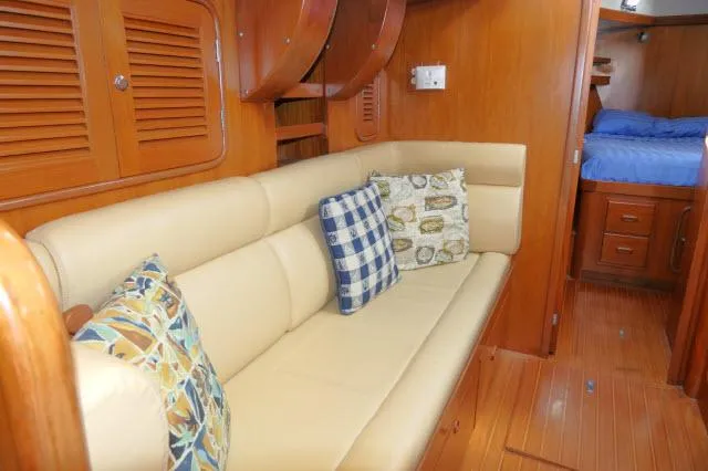 Peregrine Yacht Photos Pics Luxurious interior of 2002 Tayana 460 Vancouver Pilothouse with cozy seating and cushions.