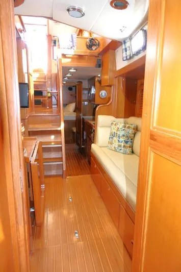 Peregrine Yacht Photos Pics Interior of 2002 Tayana 460 Vancouver Pilothouse with wooden finish and cozy seating area.