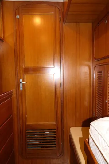 Peregrine Yacht Photos Pics Wooden interior of 2002 Tayana 460 Vancouver Pilothouse, featuring a door and storage.