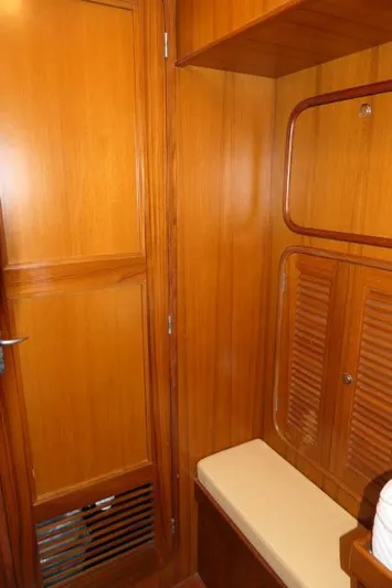 Peregrine Yacht Photos Pics Interior of 2002 Tayana 460 Vancouver Pilothouse with wooden cabinetry and cushioned seating.