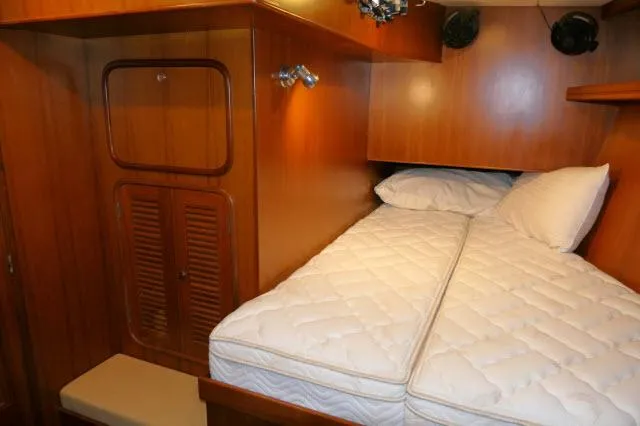 Peregrine Yacht Photos Pics Tayana 460 Vancouver Pilothouse 2002 cabin with wooden interior and comfortable bedding.
