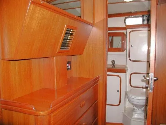 Peregrine Yacht Photos Pics Interior of 2002 Tayana 460 Vancouver Pilothouse, featuring wooden cabinetry and compact bathroom.