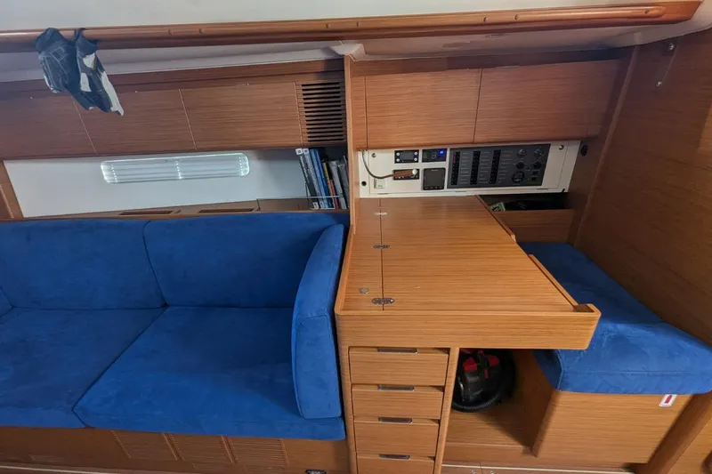 Muchacha De Abril Yacht Photos Pics Interior of 2017 X-Yachts Xc 45 with blue seating and wooden cabinetry.