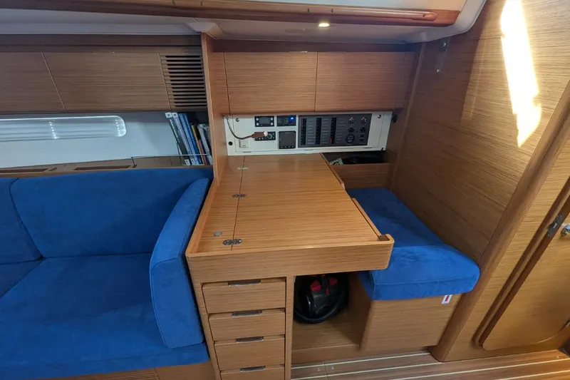 Muchacha De Abril Yacht Photos Pics Interior of 2017 X-Yachts Xc 45 with blue seating and wooden cabinetry.