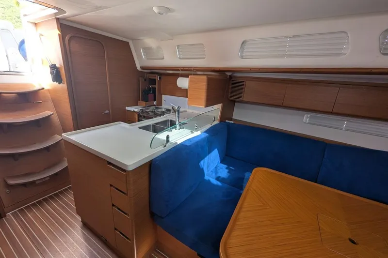 Muchacha De Abril Yacht Photos Pics Interior of 2017 X-Yachts Xc 45 sailboat with modern kitchen and blue seating area.