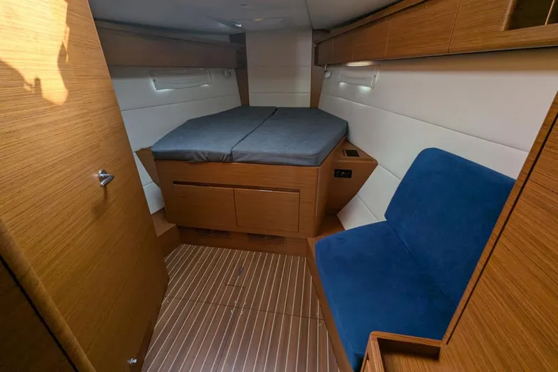 Muchacha De Abril Yacht Photos Pics 2017 X-Yachts Xc 45 cabin interior with wooden finish and blue seating.