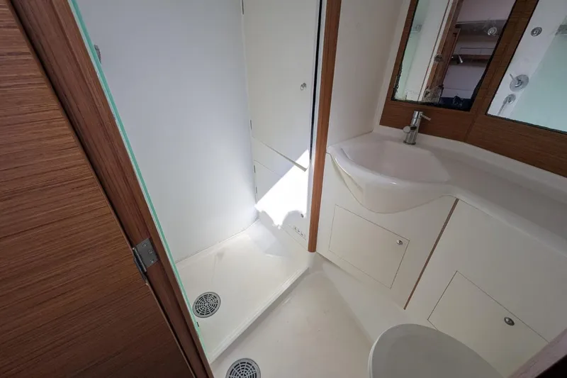 Muchacha De Abril Yacht Photos Pics 2017 X-Yachts Xc 45 yacht bathroom with shower, sink, and wooden accents.