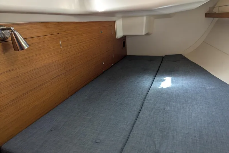 Muchacha De Abril Yacht Photos Pics Cozy cabin interior of 2017 X-Yachts Xc 45 with wooden paneling and blue cushions.