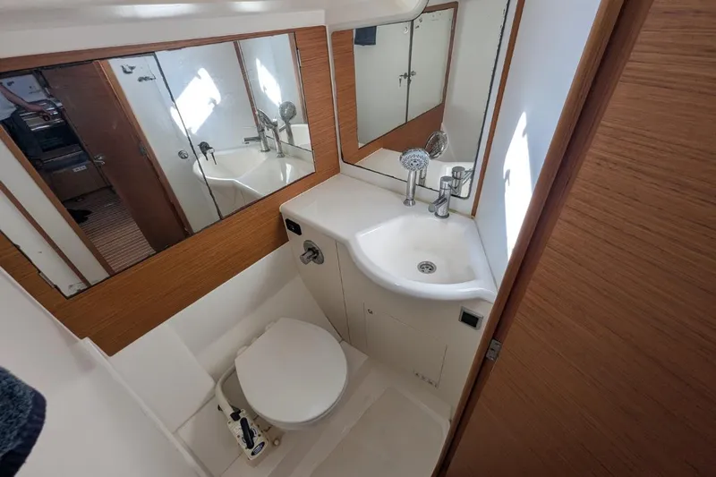 Muchacha De Abril Yacht Photos Pics Compact bathroom in 2017 X-Yachts Xc 45, featuring sink, toilet, and mirrored cabinet.