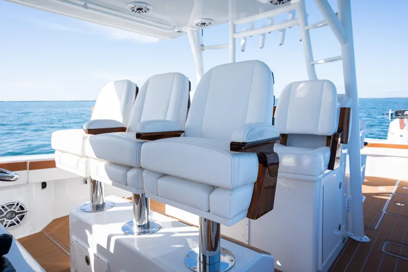  Yacht Photos Pics Luxury seating on a 2022 Freeman 47 boat with ocean backdrop.