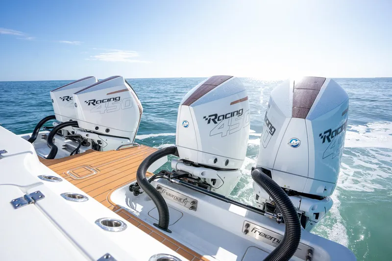  Yacht Photos Pics Freeman 47 boat with triple Mercury Racing outboard engines, 2022 model, on open water.