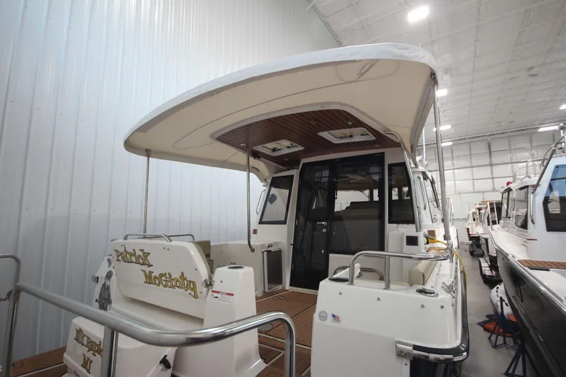Patrick Mcginty Yacht Photos Pics 2022 Ranger Tugs R-29 Sedan Luxury Edition in a spacious indoor showroom.