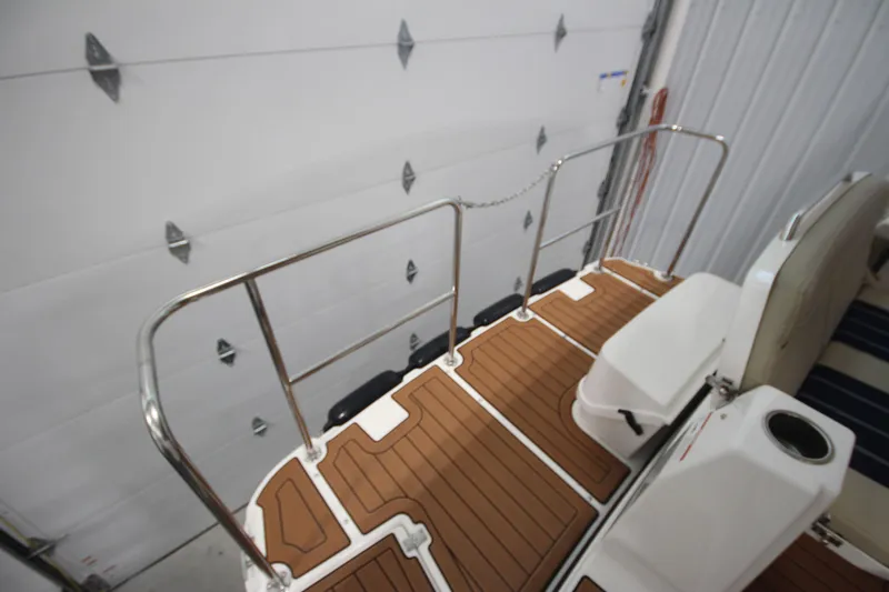 Patrick Mcginty Yacht Photos Pics 2022 Ranger Tugs R-29 Sedan Luxury Edition boat deck with teak flooring and stainless steel railings.