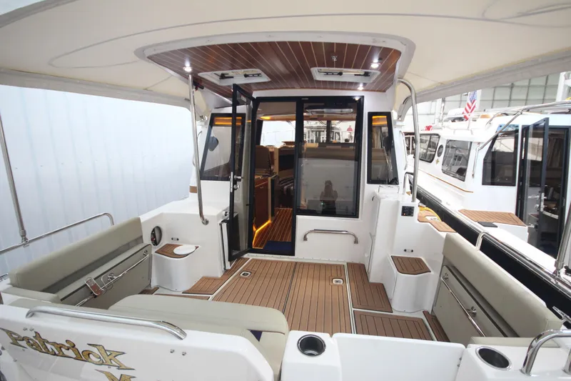 Patrick Mcginty Yacht Photos Pics 2022 Ranger Tugs R-29 Sedan Luxury Edition boat interior with seating and wood accents.