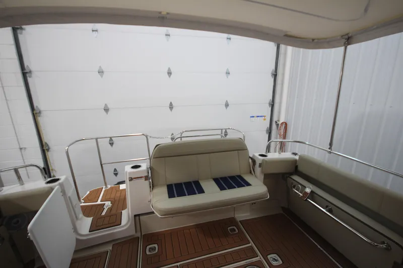 Patrick Mcginty Yacht Photos Pics 2022 Ranger Tugs R-29 Sedan Luxury Edition interior with seating and teak flooring.
