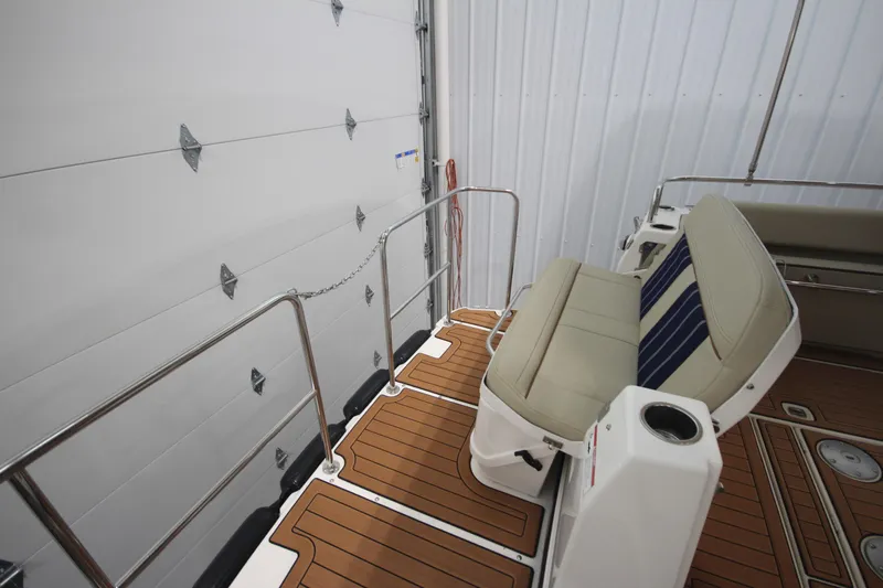 Patrick Mcginty Yacht Photos Pics 2022 Ranger Tugs R-29 Sedan Luxury Edition boat interior with cushioned seating and wood flooring.