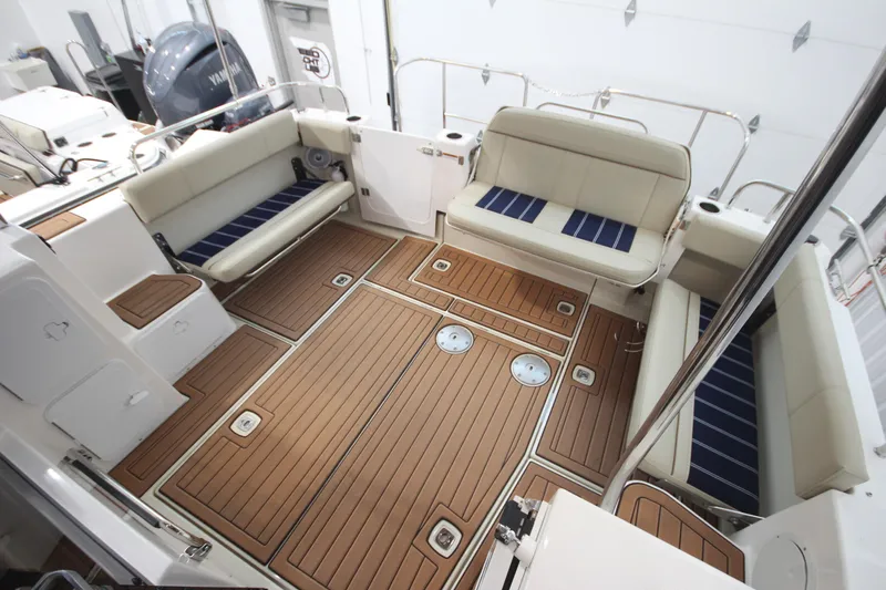 Patrick Mcginty Yacht Photos Pics 2022 Ranger Tugs R-29 Sedan Luxury Edition boat interior with teak flooring and cushioned seating.