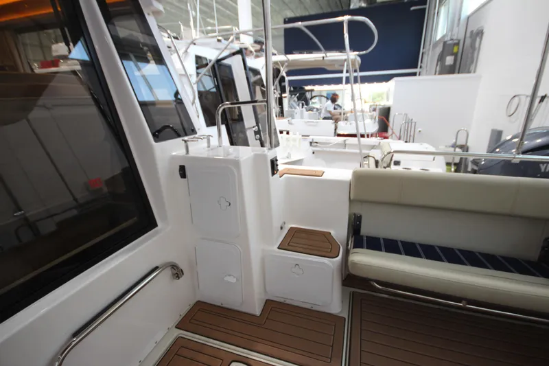 Patrick Mcginty Yacht Photos Pics 2022 Ranger Tugs R-29 Sedan Luxury Edition interior with seating and teak flooring.