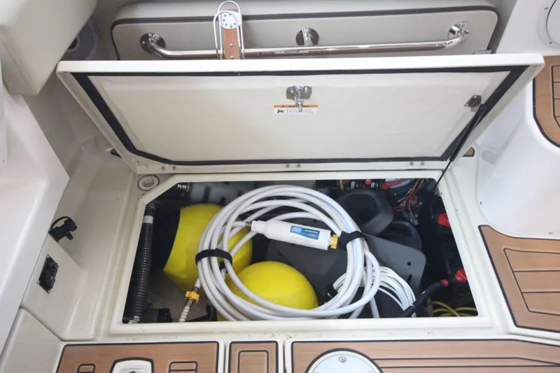 Patrick Mcginty Yacht Photos Pics Storage compartment of 2022 Ranger Tugs R-29 Sedan Luxury Edition with equipment and hoses.