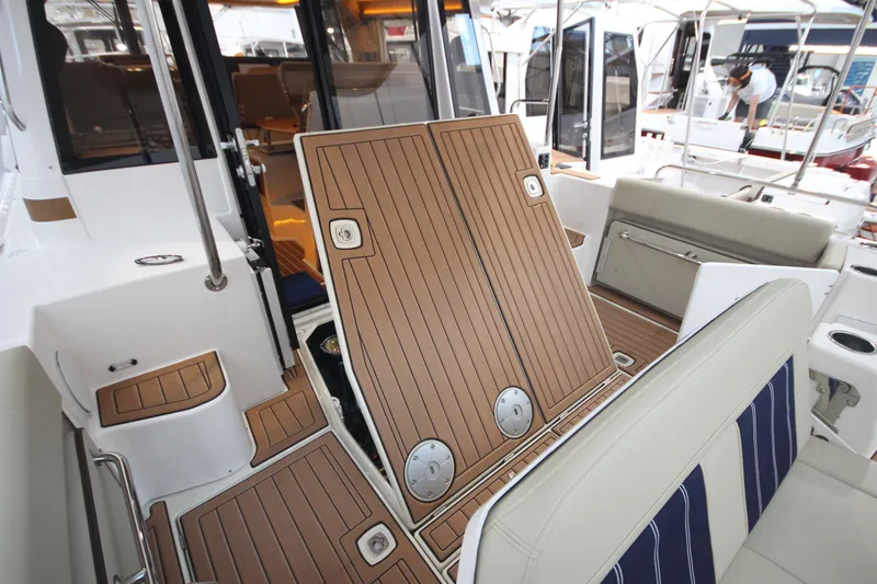 Patrick Mcginty Yacht Photos Pics 2022 Ranger Tugs R-29 Sedan Luxury Edition interior with wood finish and seating area.