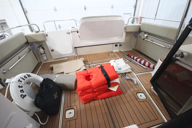 Patrick Mcginty Yacht Photos Pics 2022 Ranger Tugs R-29 Sedan Luxury Edition boat deck with life jackets and safety equipment.