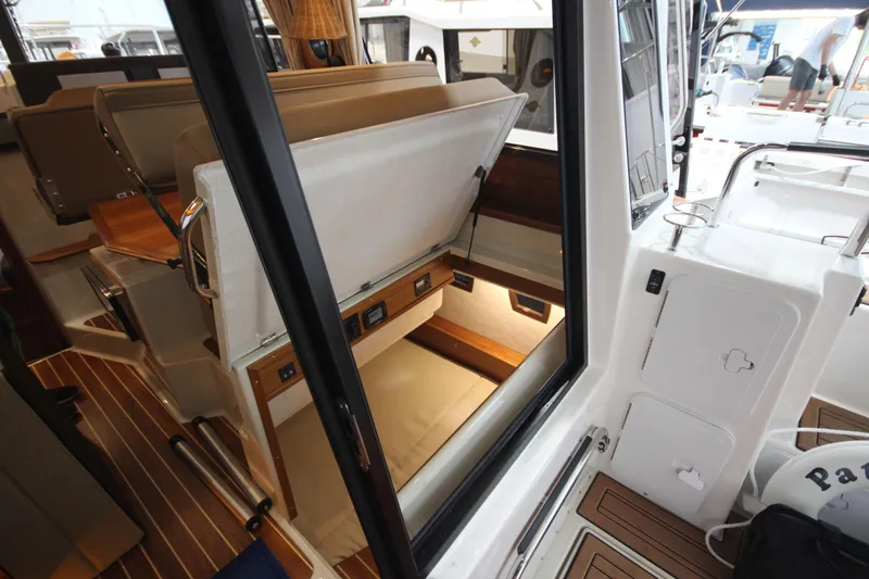 Patrick Mcginty Yacht Photos Pics 2022 Ranger Tugs R-29 Sedan Luxury Edition interior with open storage compartment.