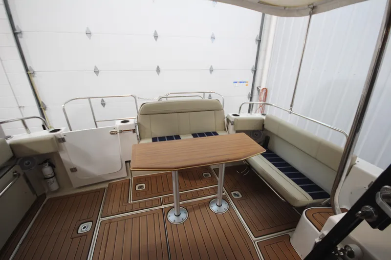 Patrick Mcginty Yacht Photos Pics 2022 Ranger Tugs R-29 Sedan Luxury Edition interior with seating and wooden table.