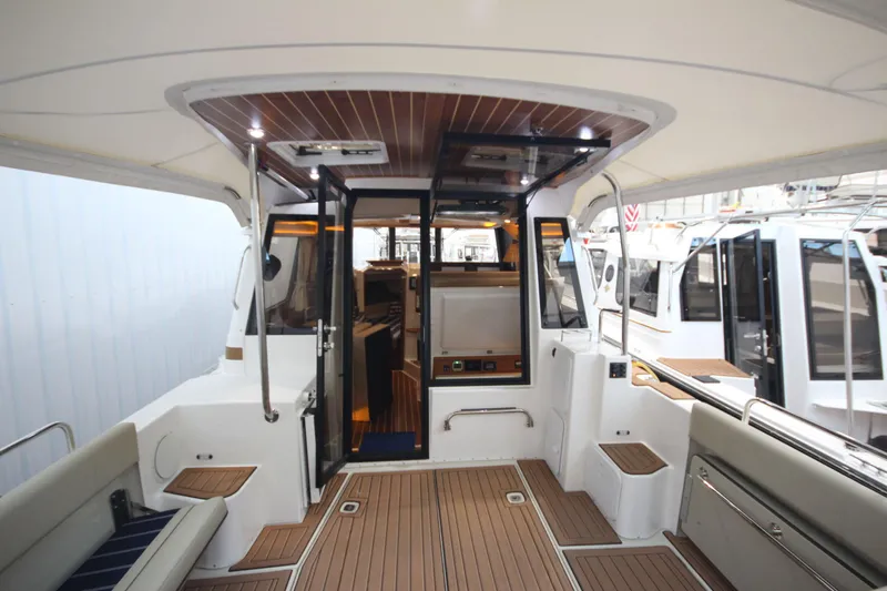 Patrick Mcginty Yacht Photos Pics 2022 Ranger Tugs R-29 Sedan Luxury Edition interior with teak flooring and modern design.