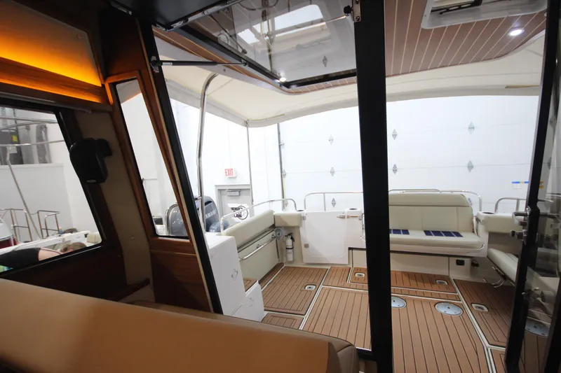 Patrick Mcginty Yacht Photos Pics Interior of 2022 Ranger Tugs R-29 Sedan Luxury Edition with elegant seating and wood flooring.