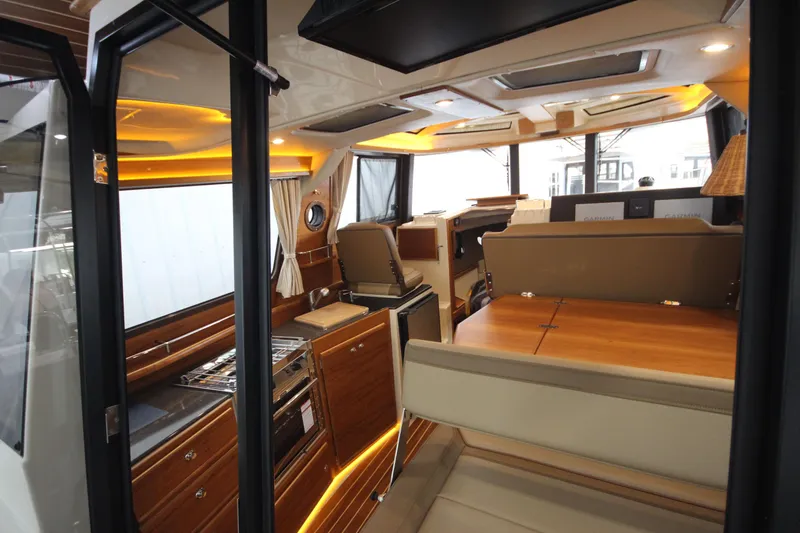 Patrick Mcginty Yacht Photos Pics Interior of 2022 Ranger Tugs R-29 Sedan Luxury Edition, featuring elegant wood finishes and modern lighting.