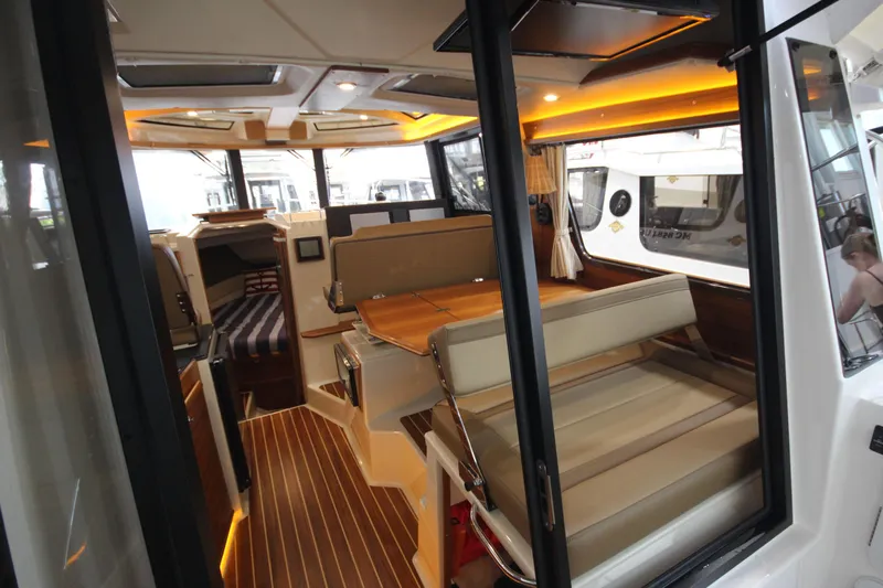 Patrick Mcginty Yacht Photos Pics Interior of 2022 Ranger Tugs R-29 Sedan Luxury Edition, featuring elegant seating and wood flooring.