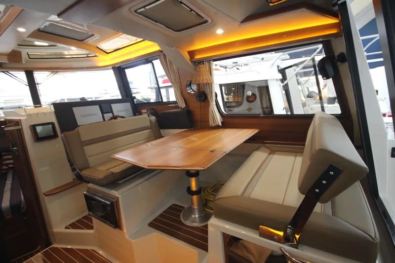 Patrick Mcginty Yacht Photos Pics 2022 Ranger Tugs R-29 Sedan Luxury Edition interior with elegant seating and wooden table.