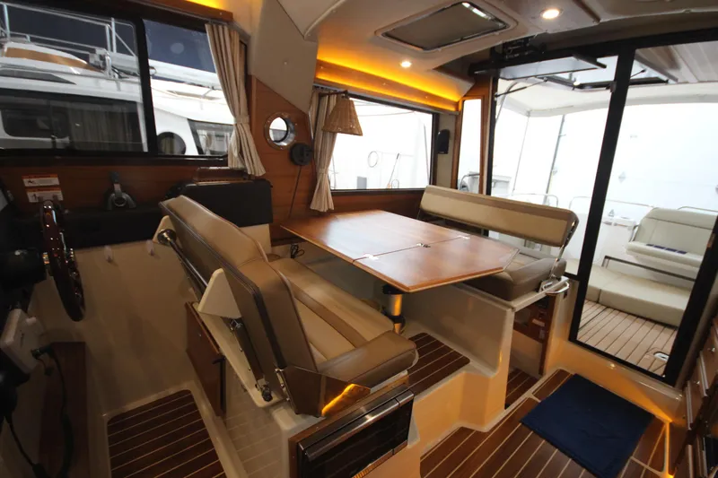 Patrick Mcginty Yacht Photos Pics 2022 Ranger Tugs R-29 Sedan Luxury Edition interior with elegant seating and wooden accents.