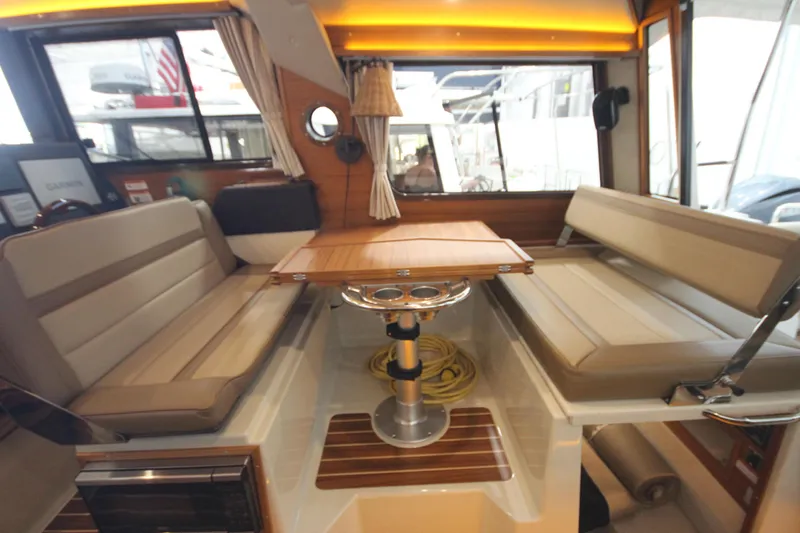 Patrick Mcginty Yacht Photos Pics Interior of 2022 Ranger Tugs R-29 Sedan Luxury Edition with seating and table.
