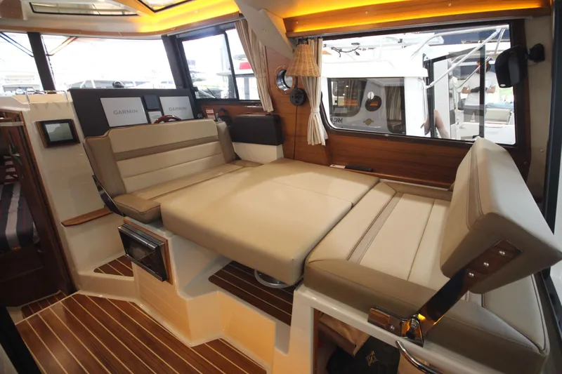 Patrick Mcginty Yacht Photos Pics 2022 Ranger Tugs R-29 Sedan Luxury Edition interior with convertible seating and wood flooring.