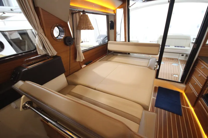 Patrick Mcginty Yacht Photos Pics 2022 Ranger Tugs R-29 Sedan Luxury Edition interior with convertible seating and elegant wood finishes.