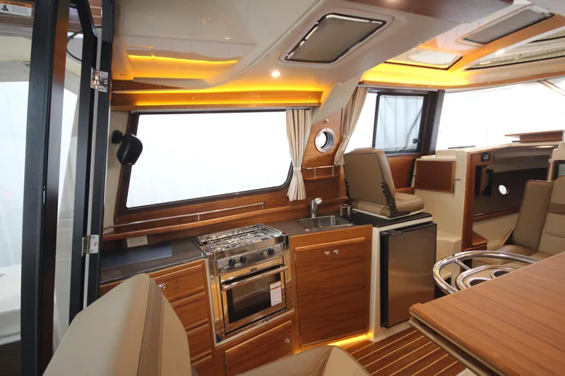 Patrick Mcginty Yacht Photos Pics 2022 Ranger Tugs R-29 Sedan Luxury Edition interior with modern kitchen and seating area.