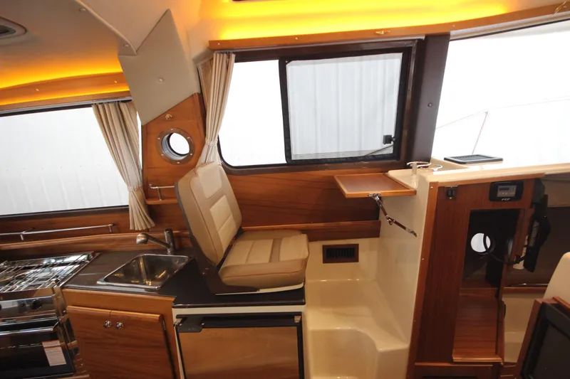 Patrick Mcginty Yacht Photos Pics Interior of 2022 Ranger Tugs R-29 Sedan Luxury Edition with wood finish and seating.