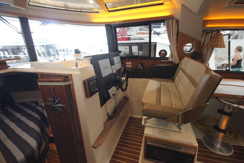 Patrick Mcginty Yacht Photos Pics Interior of 2022 Ranger Tugs R-29 Sedan Luxury Edition with helm and seating area.