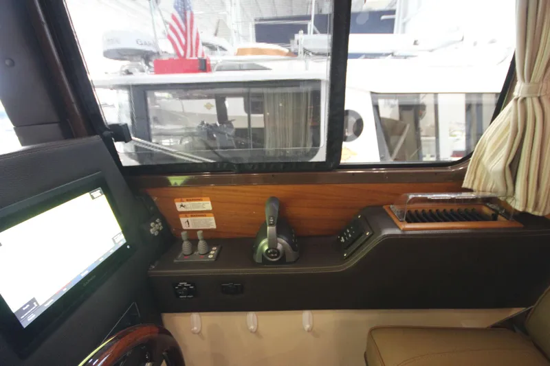 Patrick Mcginty Yacht Photos Pics Interior of 2022 Ranger Tugs R-29 Sedan Luxury Edition, featuring control panel and window view.